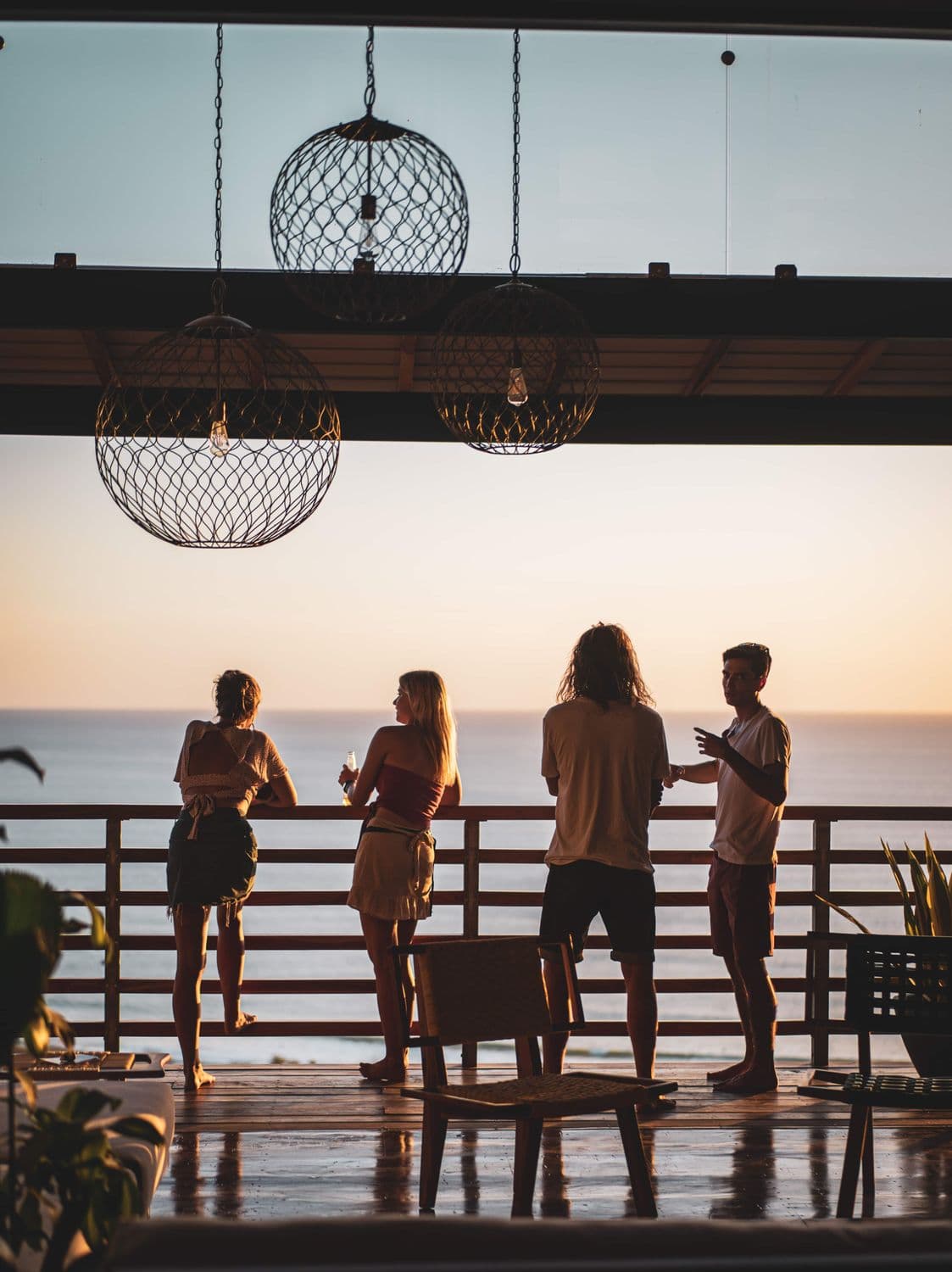 Guests on Outsite Maramar's ocean-facing terrace at sunset